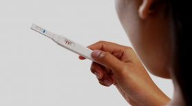 woman holding pregnancy test