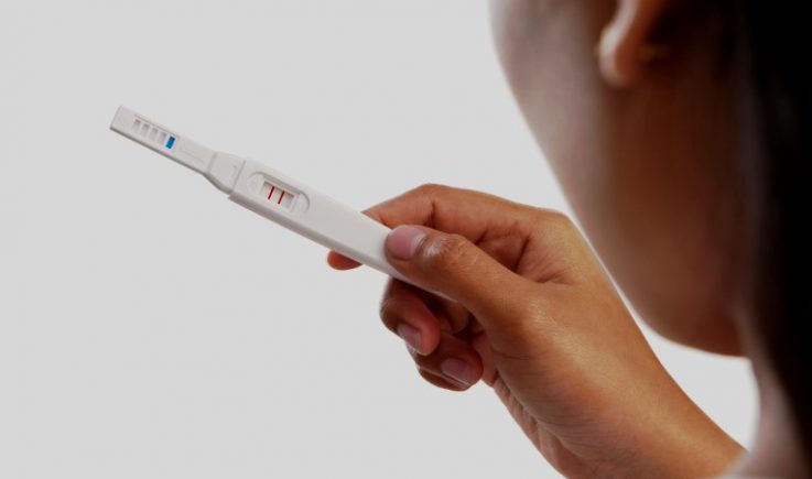 woman holding pregnancy test