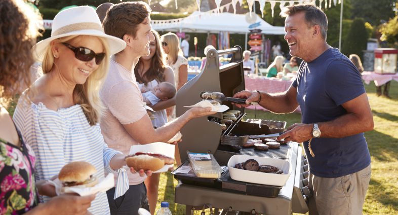 man serving barbeque to group