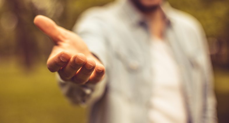 man offering hand palm up to camera