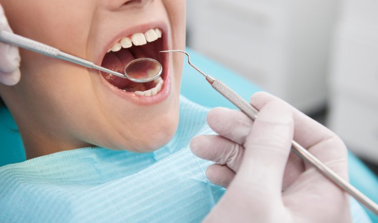 child getting teeth cleaned at dentist