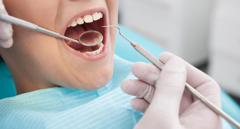 child getting teeth cleaned at dentist