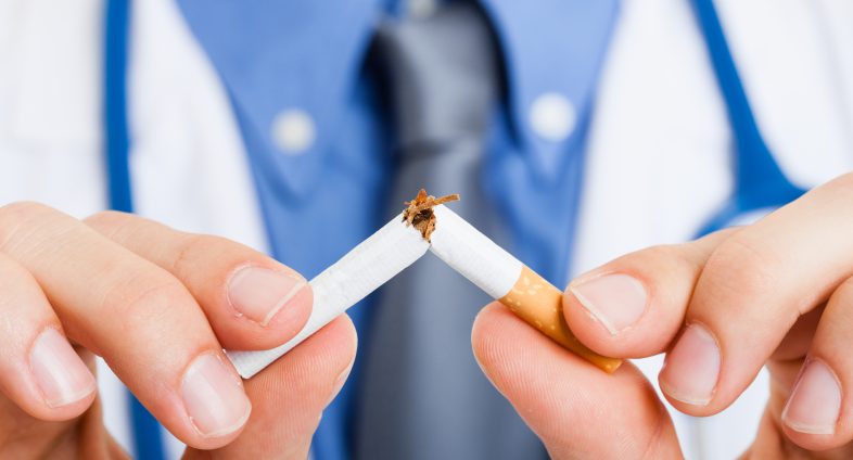 Doctor breaking a cigarette in half