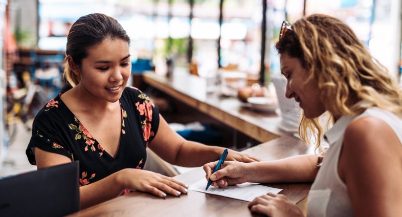 woman reviewing form at reception desk