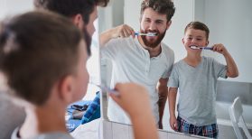 dad and son brushing teeth