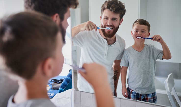 dad and son brushing teeth