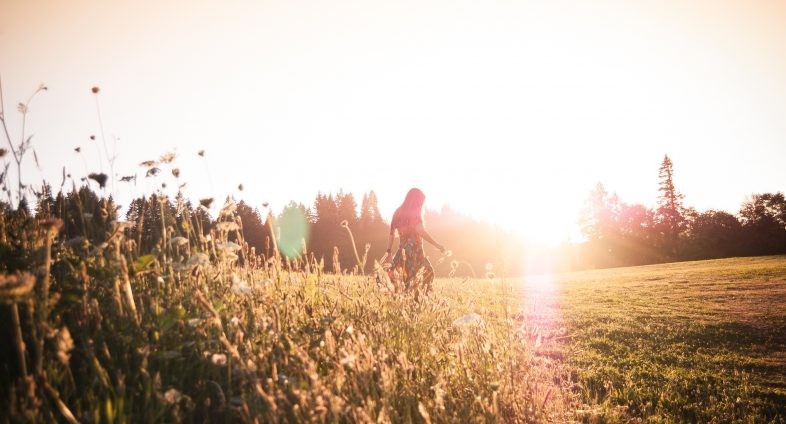 walking in long grass at sunset