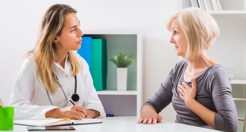 young female doctor talks to senior aged woman