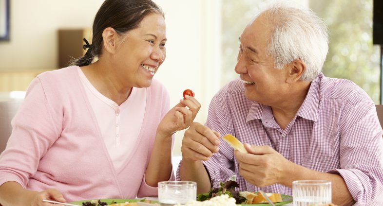 Senior asian couple eating healthy food
