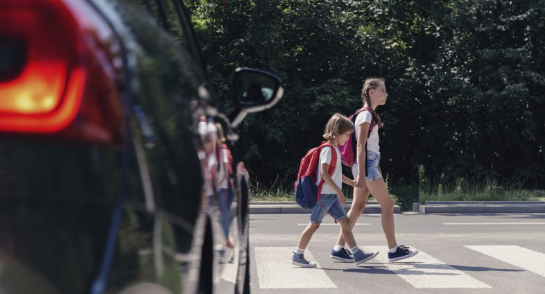 two girls crossing road
