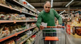 man pushing cart in grocery store