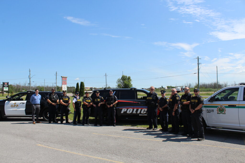 Image of officer from Quinte Regional Traffic Coalition partners and Dr. Toumishey, as part of "Safe on 62" initiative.